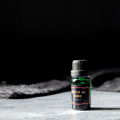 Burn it All Down perfume oil on a dark background